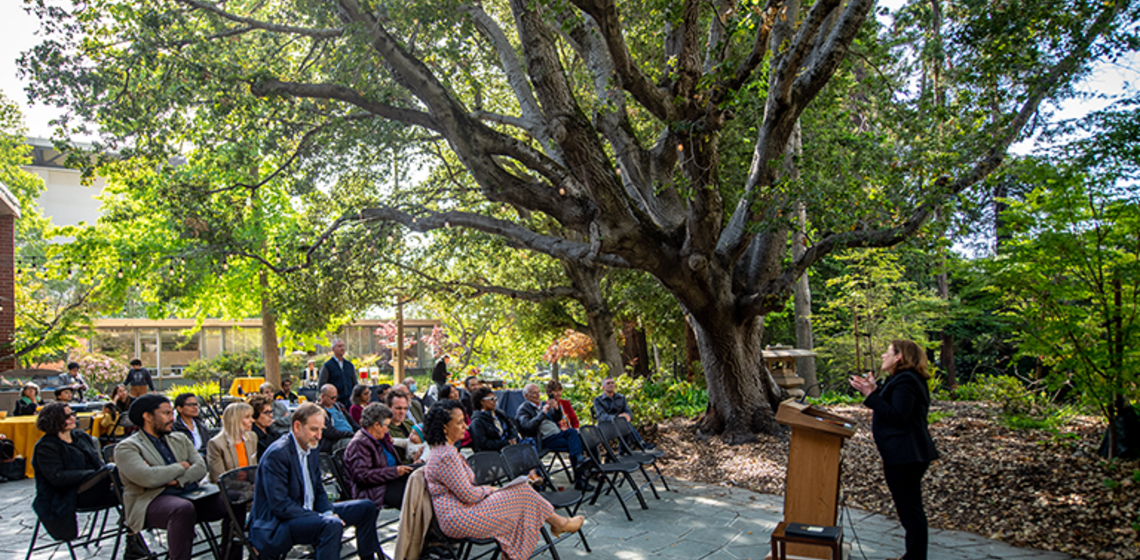Speaker at podium addresses audience at award ceremony